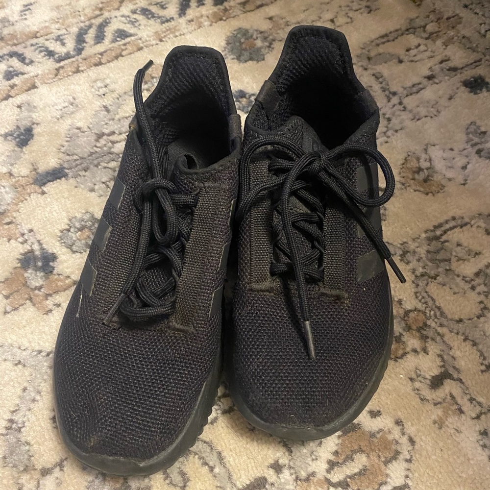 Black on black Adidas tennis shoes